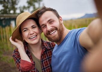 Fototapeta premium Smile, selfie and nature of happy couple in the countryside smiling, bonding and taking a photo together. Smiling man and woman embracing life, love and relationship in a natural outdoor background.