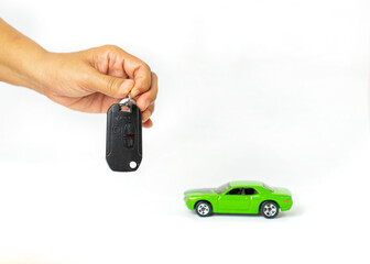 Woman holding key and automobile model on isolate white background,