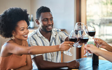 Black couple celebrating their anniversary with friends, toasting and drinking red wine. Happy...