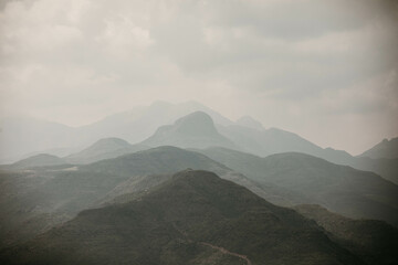layers of misty and cloudy mountains in lesotho africa - obrazy, fototapety, plakaty