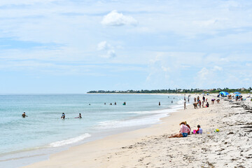 Fototapeta na wymiar People enjoying a relaxing beach day in Vero Beach, Florida on Hutchinson Island