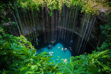 Ik-Kil Cenote, Mexico. Lovely cenote in Yucatan Peninsulla with transparent waters and hanging roots. Chichen Itza, Central America. - obrazy, fototapety, plakaty