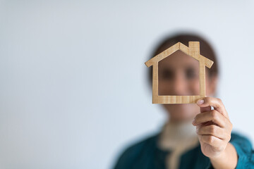 Real estate agent with house model of his hand - Business mortgage, property loan, house insurance,...