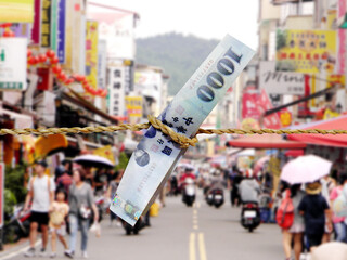 Abstract blurred image of paper money tied on rope on supermarket background. Bar charts and...