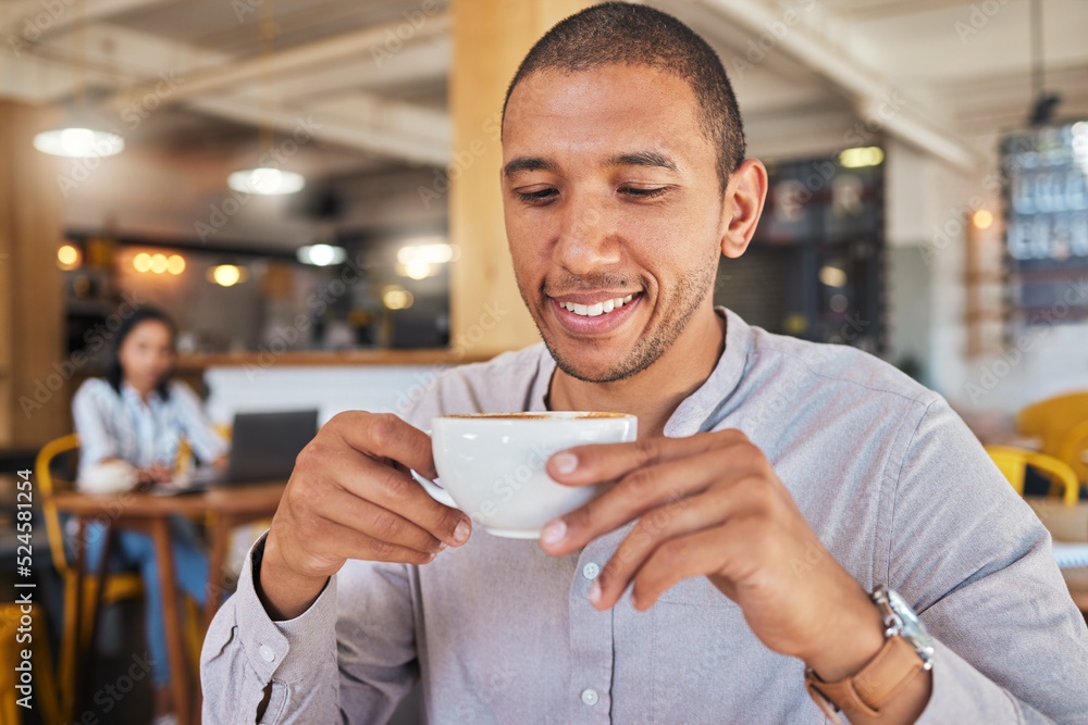 Canvas Prints Man enjoying a cup of coffee, while smiling and sitting at a cafe relaxing. Businessman drinking tea or caffeine at restaurant. Relaxed and happy male holding a mug or beverage in a coffee shop