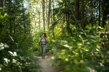 Fototapeta premium U.S. Army female soldier putting in the miles with an early morning hike in the NorthWest.