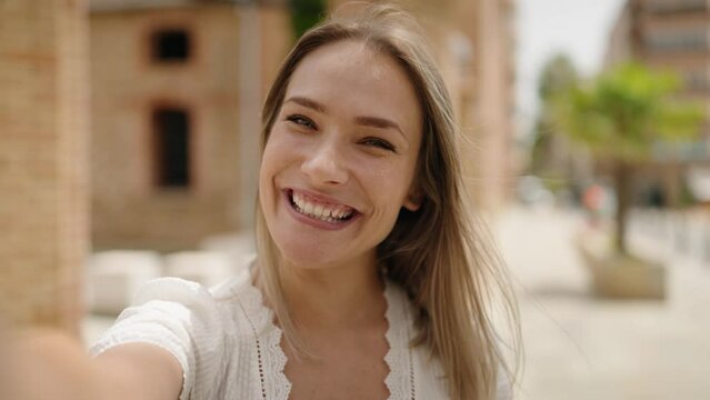Young caucasian woman smiling confident having video call at street