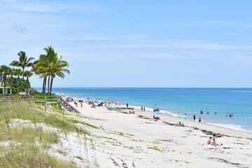 Tourists and locals enjoying a sunny Vero Beach day in Florida on Hutchinson Island