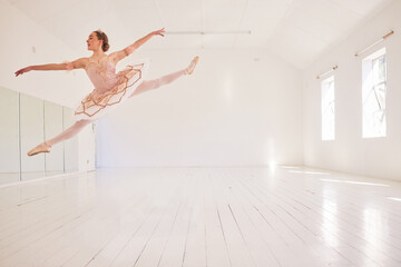 Ballet, dance and jumping in studio with classy performance and agility. Fit and beautiful ballerina moving in room with elegant energy. Dancing woman with style, grace and flexibility in her motion.