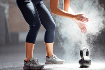Fit, dust, kettle bell of female in fitness clapping hands of chalk in the gym. Healthy, wellness...