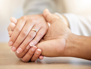 .Couple engagement with hands holding and presenting a diamond ring for a save the date announcement. Love, hope and trust between a man and woman with jewelry ready for a future wedding celebration.