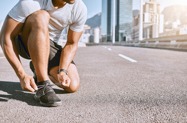 Tie shoes, wellness and fitness male runner ready for run, exercise and workout or cardio training. Healthy, fit and active male jogger preparing for jogging, exercising or physical activity