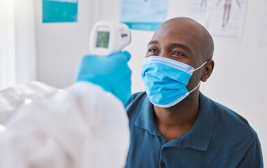 Man doing covid temperature check with medical doctor, checking for fever during checkup and wearing a mask to protect from virus. Expert, professional or healthcare worker consulting and doing exam