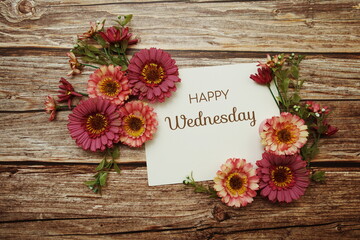 Happy Wednesday typography text with flowers on wooden background