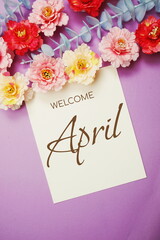 Welcome April typography text and flower decorate on purple background