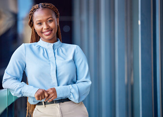 Corporate business woman standing on balcony outside at work, taking a break and looking confident....