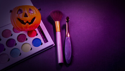 Makeup themed halloween banner with a pumpkin and ample copy space