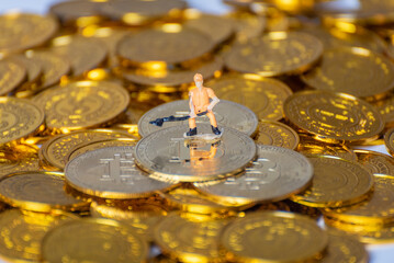 Miner worker standing on virtual currency and a lot of gold coins (symbolizing virtual currency mining)