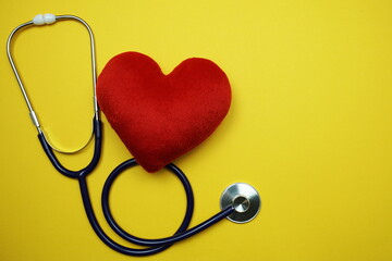 Heart and Stethoscope with space copy on yellow background