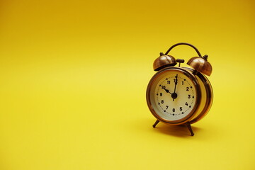 Alarm clock with space copy on yellow background