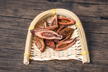 Dried betel nut products on wooden table and in bamboo basket