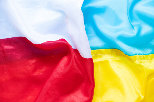 The Flag Of Poland And The Flag Of Ukraine As A Background, An Alliance Between The Two Countries During The War In Ukraine 2022