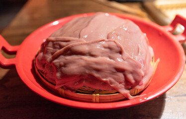 Traditional Chinese hot pot ingredients on a plate - pork loin (pig's kidney)