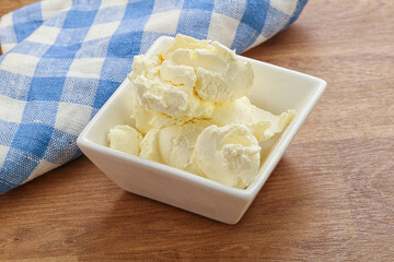 Italian soft mascarpone cheese in the bowl