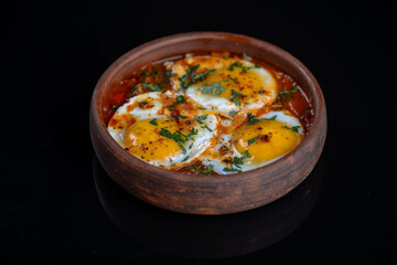 fried scrambled eggs in a clay pan
