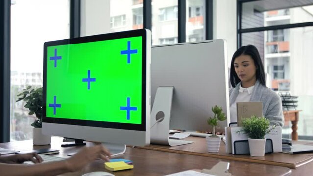 Green screen, mockup and tracking markers with business people at work on computer . Women workers at company desk in corporate advertising office working on desktop technology in a marketing startup
