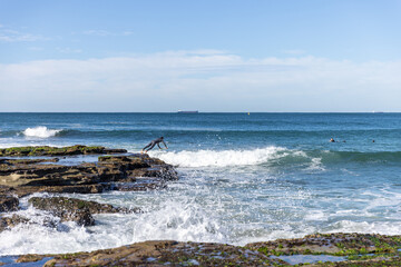 Surfer diving in waves