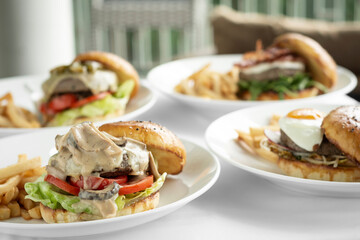 selection of many different burgers on restaurant table