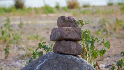 stapled brick stones, dry grass as background