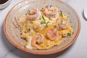 Creamy omelette with shrimps on rice served fish sauce, Thai style