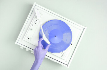 DJ Turntable, Hand Placing Tonearm on white Vinyl Record. Music concept. Top View