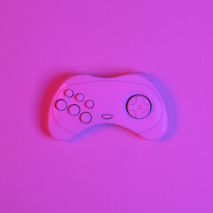 White gamepad in pink-blue neon gradient light. Minimalism gaming concept