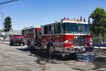 Fototapeta na wymiar A San Jose Fire Engine on the scene for a small grass fire in a San Jose Neighborhood