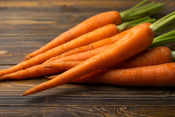 Fresh carrots on brown texture background. Ingredient for salad.Vegetarian organic vegetables.Healthy food.Copy space.Place for text