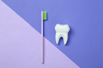 Eco-friendly bamboo and toothbrush and tooth on  colored background. Dental care concept..Top view.
