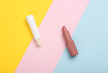 Hygienic and pink make-up lipstick on a colored background. Creative beauty layout. Top view