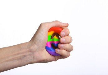 Female hand squeezing antistress snapperz toy on white background