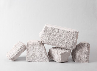 Minimalistic composition with natural porous white stones on a gray background