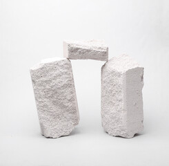 Minimalistic composition with natural porous white stones on a gray background