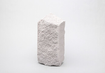 Natural porous white bricks on a gray background