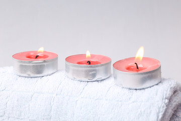 Aromatherapy, spa salon. Scented candles on towel