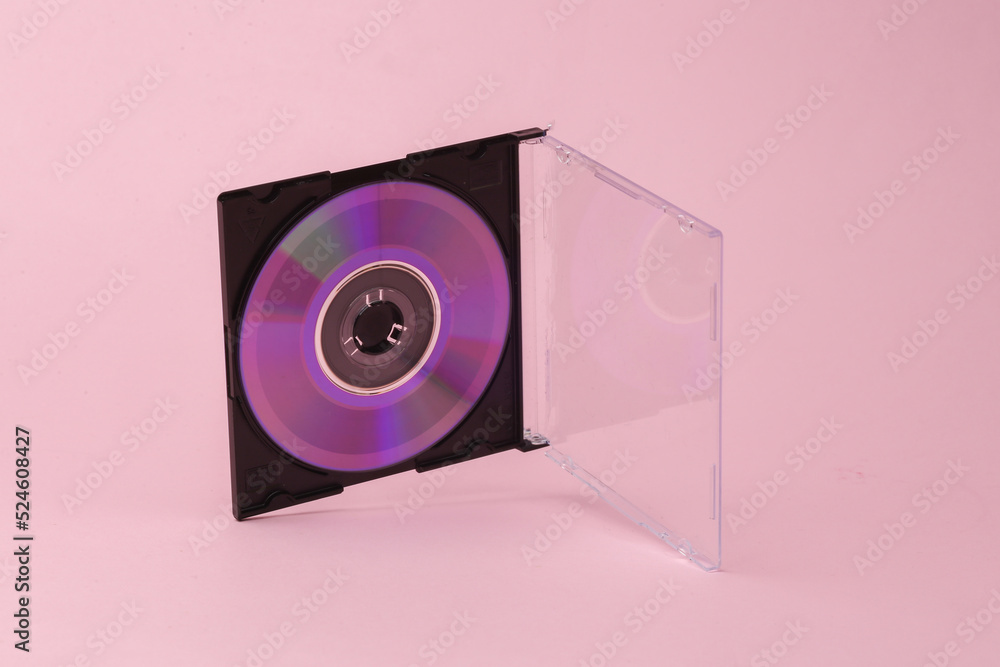 Poster cd disk in box flying in antigravity on pink background with shadow. levitation object in the air. c
