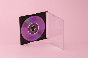 Cd disk in box flying in antigravity on pink background with shadow. Levitation object in the air. Creative minimal layout