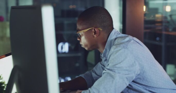 Working, typing and writing business man on a office computer online multitasking at night. Digital internet tech developer reading a funny email at work busy with iot, web and blockchain research