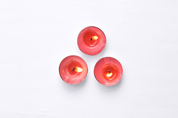 Flaming aroma candles on a white background. Top view