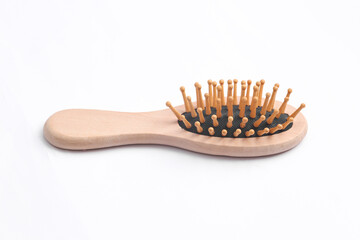 Wooden eco hair brush on a white background.